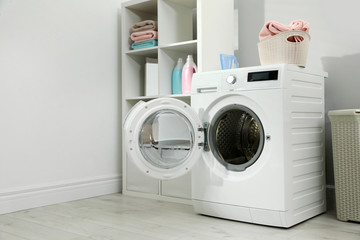 Modern washing machine in laundry room interior. Space for design