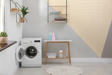 Modern washing machine in laundry room interior. Space for design