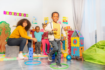 Kids jump from ring to another in nursery school