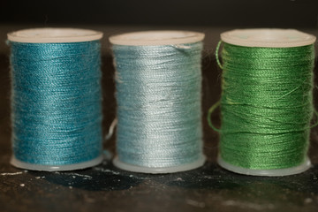 Three spools of sewing cotton