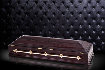 closed wooden brown sarcophagus isolated on gray luxury background. casket, coffin on royal...