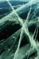 Sun rays are refracted by the transparent ice of Lake Baikal. cracks at different depths create a bizarre web