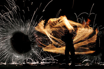 silhouette of a man during a fiery show