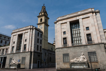 Fototapeta na wymiar Piazza CLN (acronym of National Liberation Committee ) with two fountains and the San Carlo Borromeo Church