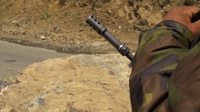 Close up of a guard's rifle barrel on the border between India and Pakistan