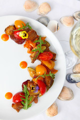 Salad from vegetables and rapanov meat. Meat shells rapanov from the Sea of Azov. Grilled vegetables with a great sauce. Blackberry top view. Still life concept.