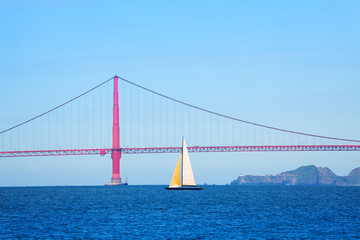 Sailboat passing under the Golden Gate Bridge, USA