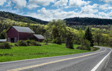 Scenic Drive in New York:  Spring colors begin to show along a country road in the Catskill Mountains of southeastern New York.