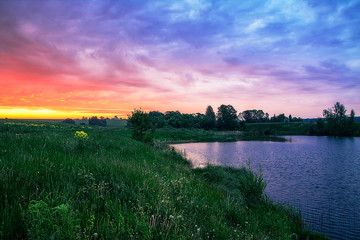 Summer very beautiful sunset over the pond