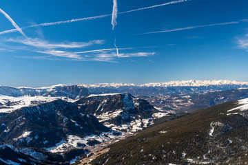 Panorama of Dolomites Alps, Val Gardena, Italy with contrails