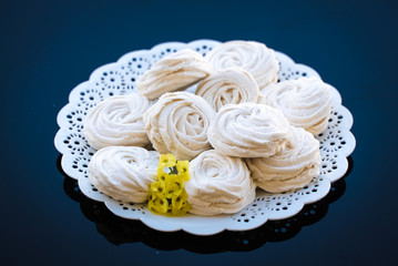 marshmallow in a white plate on a dark background