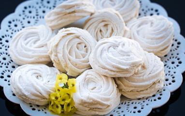 marshmallow in a white plate on a dark background