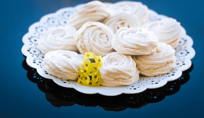 marshmallow in a white plate on a dark background
