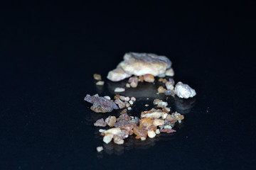 spice mix in best studio quality photographed partly isolated against black background with macro lens taken