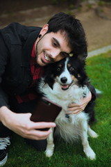 selfie boy with his dog funny face animal photo selfies  in the park with pet border collie