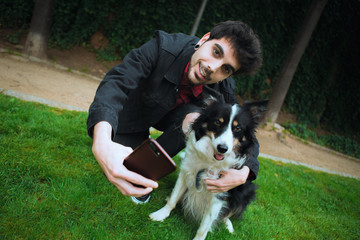 Naklejka na ściany i meble selfie boy with his dog funny face animal photo selfies in the park with pet border collie