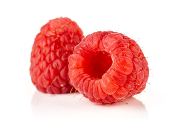 Group of two whole picked fresh red raspberry isolated on white background