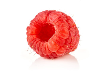 Closeup of one whole fresh red raspberry isolated on white background