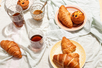 Breakfast Croissants and muffins with currants with coffee.