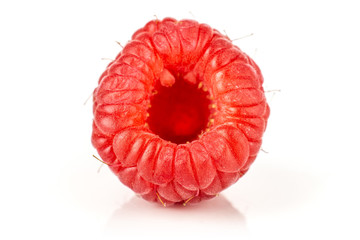 One whole hollow fresh red raspberry isolated on white background