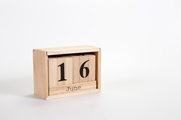 Wooden calendar June 16 on a white background