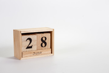 Wooden calendar June 28 on a white background