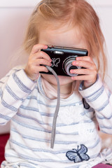 A small child with a camera