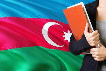 Learning Azerbaijani language concept. Young woman standing with the Azerbaijan flag in the...