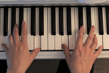 Hands playing the piano
