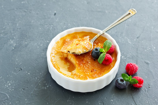 Creme brulee. dessert with caramel crust and berries.