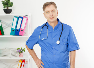 Portrait of Smiling doctor posing with the office, he is wearing a stethoscope, copy space for logo or text.