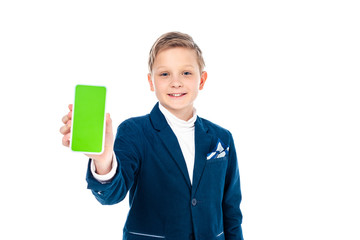 smiling schoolboy in formal wear presenting smartphone with green screen Isolated On White