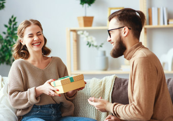 Happy married couple man and woman give a gift for holiday      .