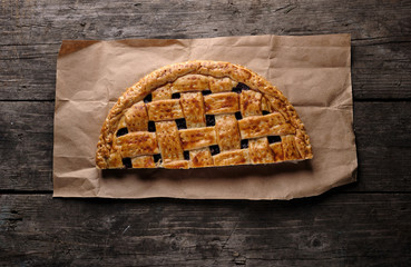 half cherry pie on brown paper