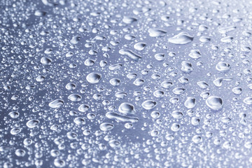 Drops of water on a gray background closeup