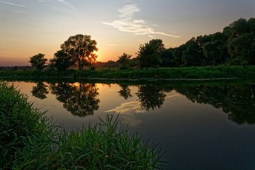 Fototapeta na wymiar Colorful sunset over the river suburban area of central Russia.