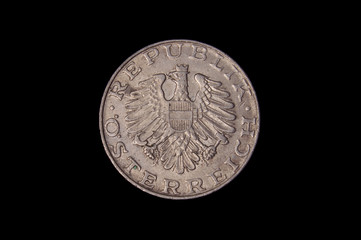Reverse of old austrian coin isolated on the dark background