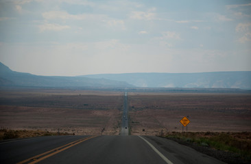 Overview over american desert with traffic sign "Blowing dust area"