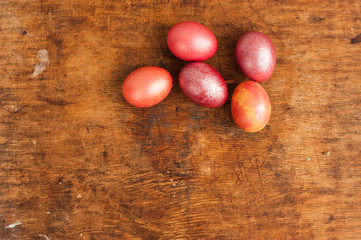 Easter eggs on a wooden background. Happy easter. Bright multicolored shiny easter eggs. Copyspace. Background with easter eggs. Place for text