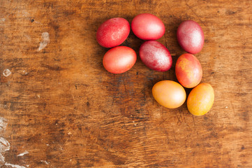Easter eggs on a wooden background. Happy easter. Bright multicolored shiny easter eggs. Copyspace. Background with easter eggs. Place for text