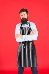 Brutal bartender. Bearded bartender in hipster style. Serious bartender wearing stylish work uniform. Restaurant bar staff. Waiter or bartender. Ready to serve you