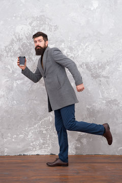 Casual style. trendy man with beard. Male fashion model. Mature businessman drink coffee on go. Modern life. Brutal bearded hipster in denim wear. Handsome young bearded man wearing coat and running