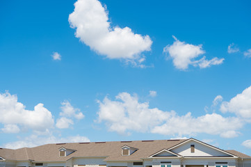 house roof on blue sunny sky background. Architecture and structure. design concept. rent an apartment. relocation. moving to a new house. Rooftop. Protection and shelter. Promoting safety for life