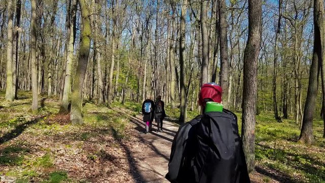 Hikers goes with dogs through the Kunraticky forest (Kunraticky les) in Prague - (4K)