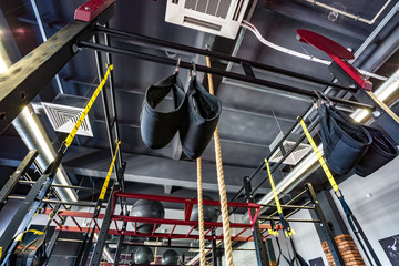 Hall of martial arts with fighting ring and punching bags and simulators in the modern Fight club
