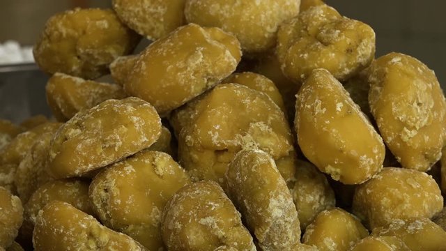 Extreme close up of dozens of sweet jaggery gur lumps in a pile