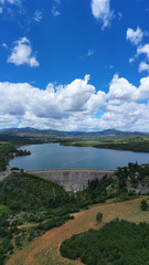 Naklejka na ściany i meble Aerial drone panoramic view of famous dam and lake of Marathon with beautiful clouds, North Attica, Greece