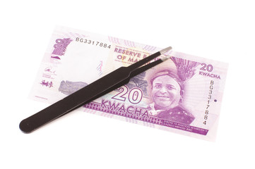 Banknote and tweezers isolated on the white background