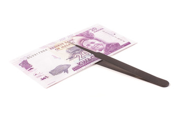 Banknote and tweezers isolated on the white background