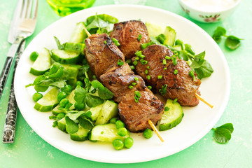 Beef kebab with cucumber and green pea salad. Healthy food.